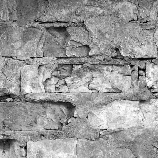 Fototapeta An image of the texture of a brick wall with a coarse-grained, embossed surface. Small cracks and cement inclusions. Horizontal image.