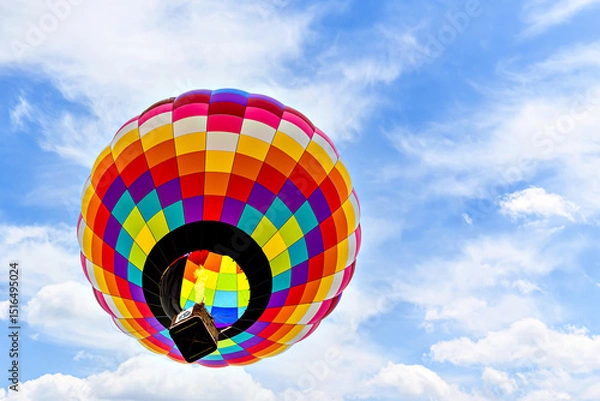 Obraz Colorful hot air balloon flying over blue sky with white clouds	