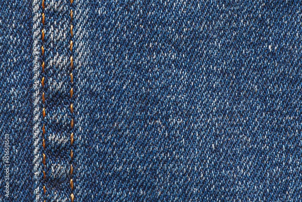 Fototapeta close up blue jeans texture with seam with orange thread at left side