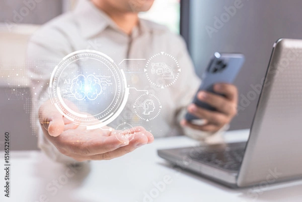 Fototapeta A person holds a smartphone near a laptop, interacting with a digital AI hologram, symbolizing advanced technology and artificial intelligence.