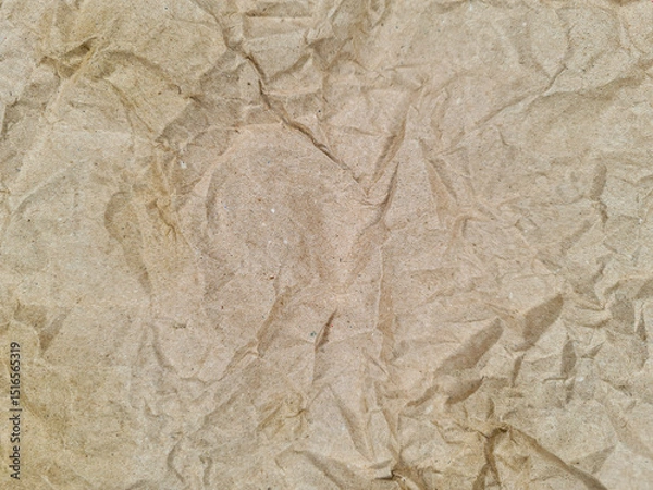 Fototapeta Crinkled, textured surface with an organic feel, displaying a pattern of various folds and creases. The brown hue suggests a natural, earthy material, with no visible writing