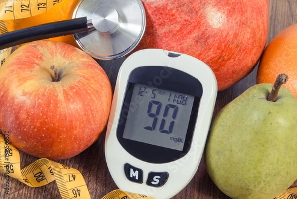Obraz Glucose meter with sugar level, fresh fruits, stethoscope and tape measure. Healthy lifestyle and nutrition during diabetes