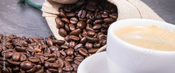 Obraz Coffee in white cup and roasted dark coffee beans in bag