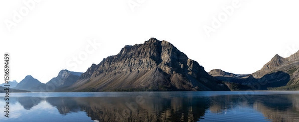 Fototapeta Panorama of large rocky mountain at sunrise reflecting in calm lake with a transparent sky
