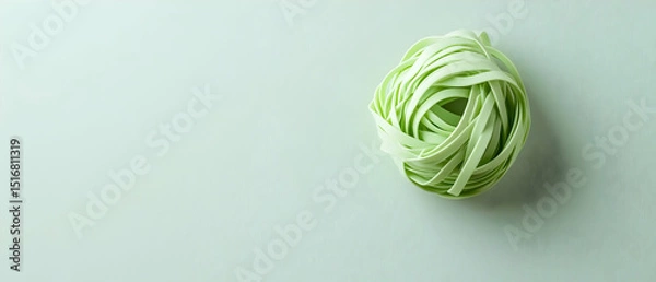 Obraz Light Green Pasta Nestled In Center On Pale Grey Surface