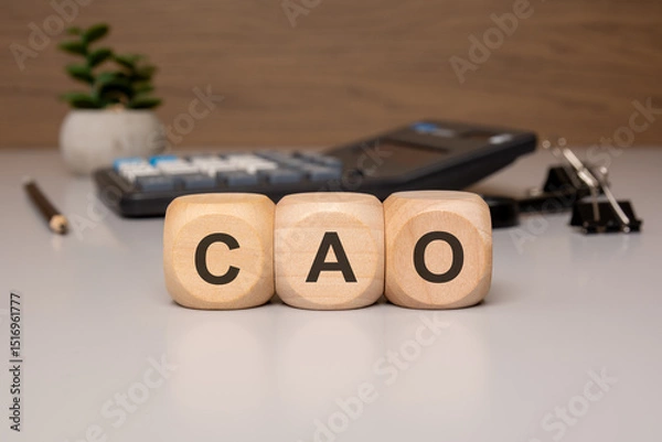 Obraz Wooden cubes with letters CAO on office desk, calculator in background