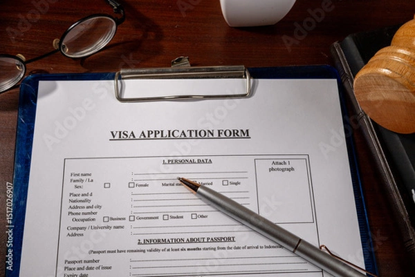 Fototapeta Visa Application Form in Clipboard on Desk – Immigration Document Scene