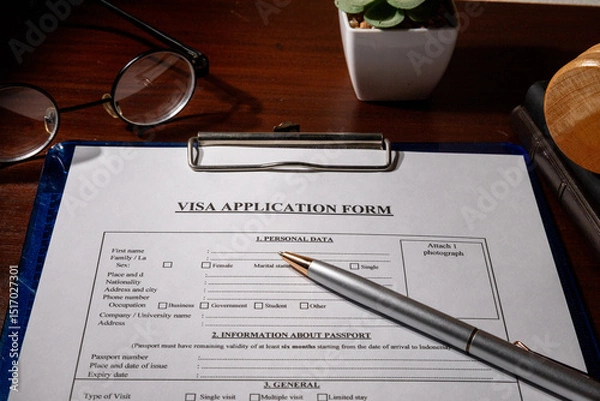 Fototapeta Visa Application Form in Clipboard on Desk – Immigration Document Scene