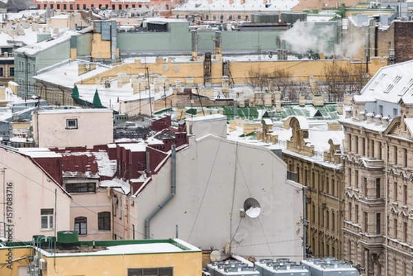 Obraz Old buildings roofs under the snow.