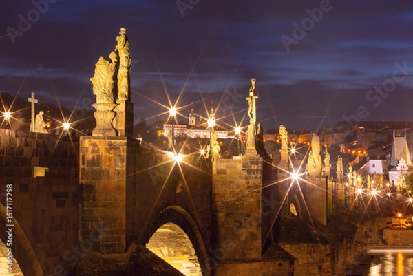 Fototapeta Illuminated Charles Bridge with baroque statues in Prague Czech Republic at night