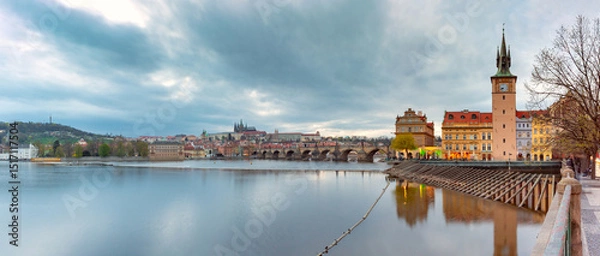 Fototapeta Sunset view of Vltava River with Charles Bridge and landmarks in Prague Czech Republic