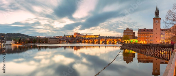 Fototapeta Sunset view of Vltava River with Charles Bridge and landmarks in Prague Czech Republic
