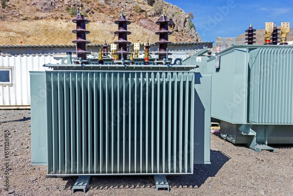 Fototapeta View of big transformer. In electrical engineering, a transformer is a passive component that transfers electrical energy from one electrical circuit to another circuit, or multiple circuits.