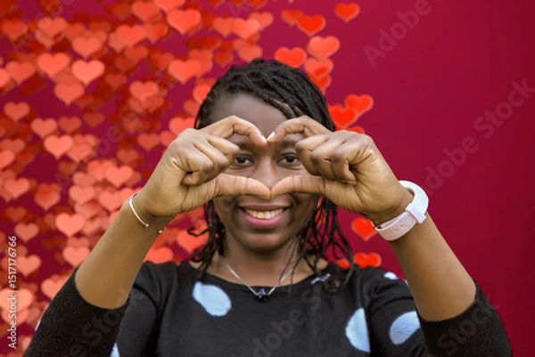 Fototapeta Smiling African Woman Making Heart Sign with Hands on Heart Bokeh Background