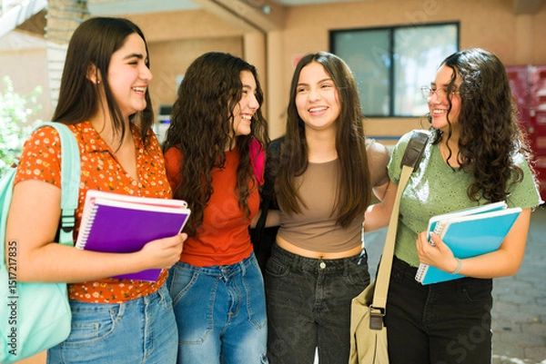 Obraz Female friends walking and laughing together in high school