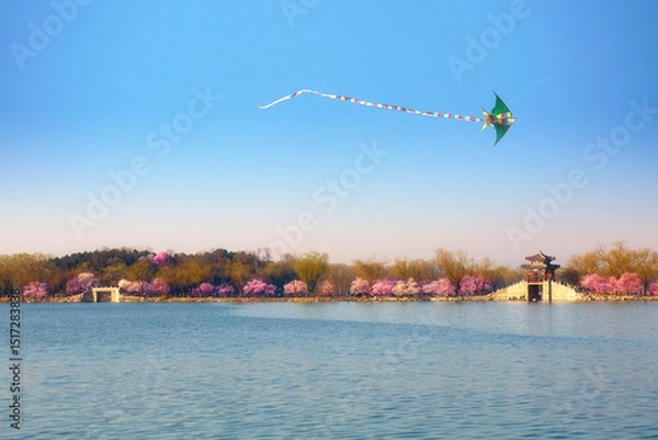 Fototapeta Beijing Summer Palace Kunming Lake with kites and West Causeway ancient architecture with peach blossoms.