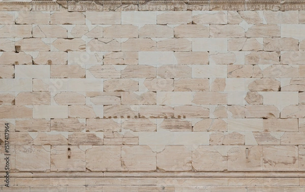 Fototapeta Smooth, weathered and cracked ancient wall made of stone blocks in Athens, Greece, viewed from the front. High resolution full frame textured background.