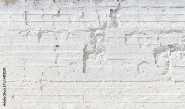 Fototapeta Old, weathered, cracked and plastered concrete wall painted in white on sunny day, viewed from the front. High resolution full frame textured background with copy space.