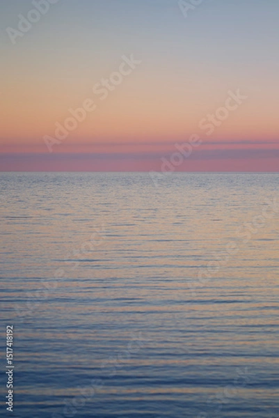 Fototapeta Beautiful and tranquil pastel-colored seascape and sky at sunset. Abstract natural landscape and background with copy space.