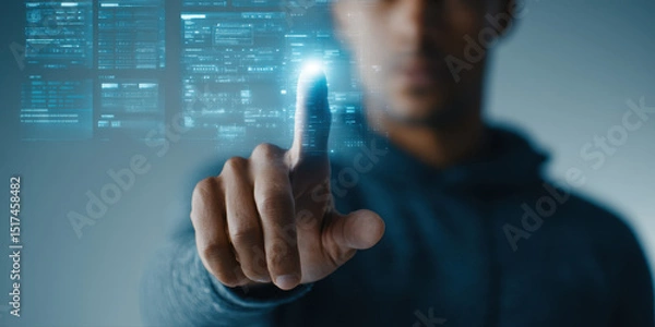 Fototapeta Man interacting with futuristic digital interface, pointing finger at glowing virtual screen with data and technology elements