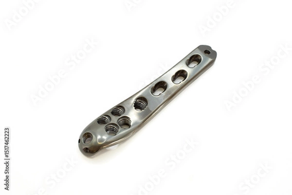 Fototapeta A sleek metal component Proximal Femur titatium plate with multiple holes, ideal for engineering and design projects