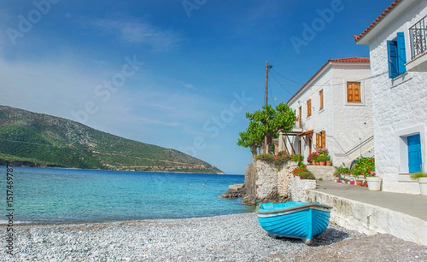 Fototapeta white house with colorful shutters of a seaside village with boats on the beach in Peloponnese Greece
