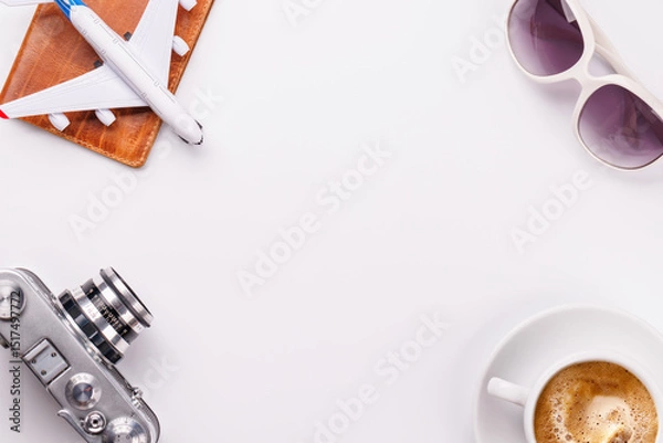 Fototapeta Travel-themed flat lay with toy airplane, camera, and coffee