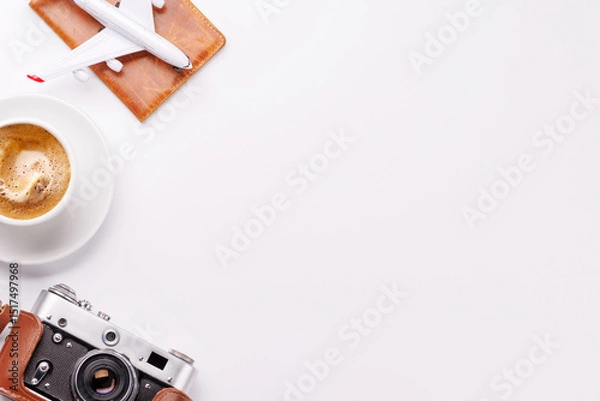 Fototapeta Travel-themed flat lay with toy airplane, camera, and coffee