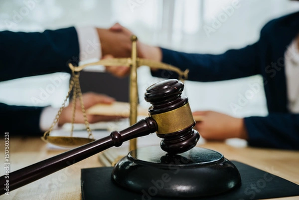 Fototapeta A lawyer consulting with a client in an office, reviewing legal documents and contracts related to justice, law, and business.