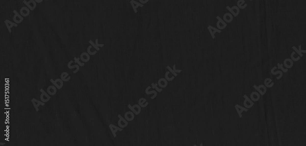 Fototapeta Black cotton or linen fabric sample for background. Close-up of a smooth, slightly reflective black fabric showcasing its texture and subtle lighting highlights, creating an elegant