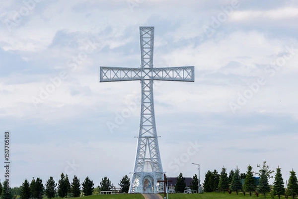 Fototapeta A wide view of the hilltop religious complex with giant cross, visitors and paths reflecting faith, architecture and landscape blending in unity