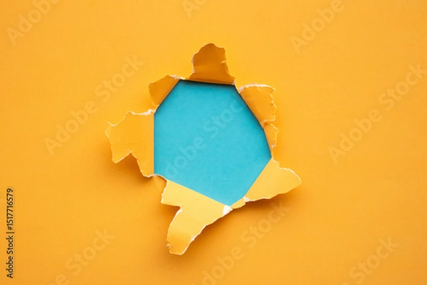 Obraz Torn ripped yellow paper hole on blue background