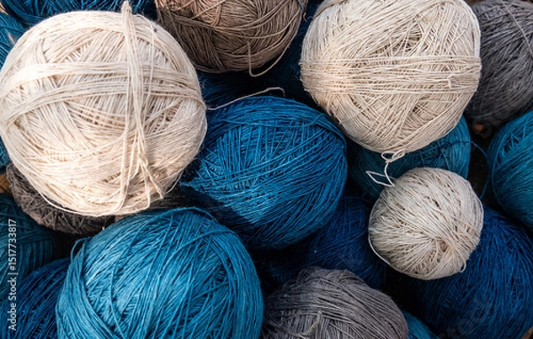 Fototapeta natural yarn ball in blue and white color. crochet yarn, knitting yarn cotton fiber mixed with hemp fiber, naturally dyed. colorful threads for needlework, cotton fabric texture pattern background