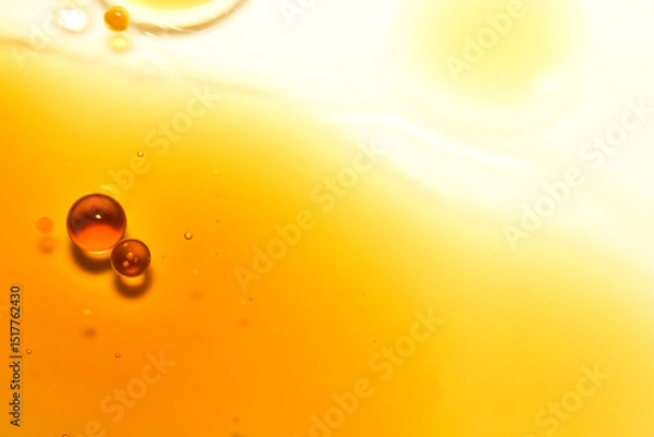 Fototapeta Macro View of Orange Oil Droplets on Smooth Bright Background