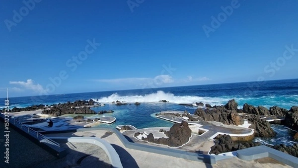 Fototapeta The Natural Pools of Porto Moniz, formed by ancient volcanic rocks, are the signature attraction of this charming coastal town in Madeira. These crystal-clear pools are naturally filled with fresh sea