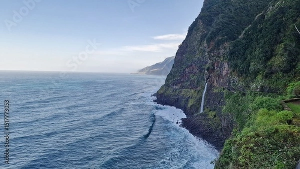 Fototapeta The Véu da Noiva viewpoint allows you to admire this abundant waterfall that erupts from the vegetation-covered slope, falling towards the sea.