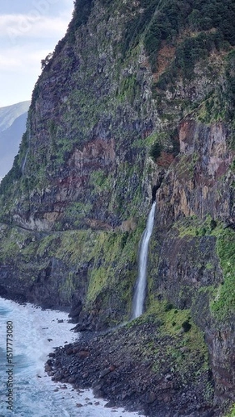 Fototapeta The Véu da Noiva viewpoint allows you to admire this abundant waterfall that erupts from the vegetation-covered slope, falling towards the sea.