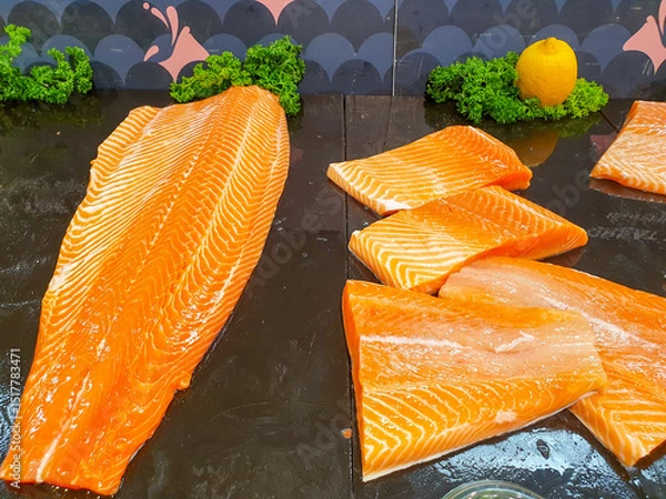 Fototapeta fresh salmon meat displayed on black shelf