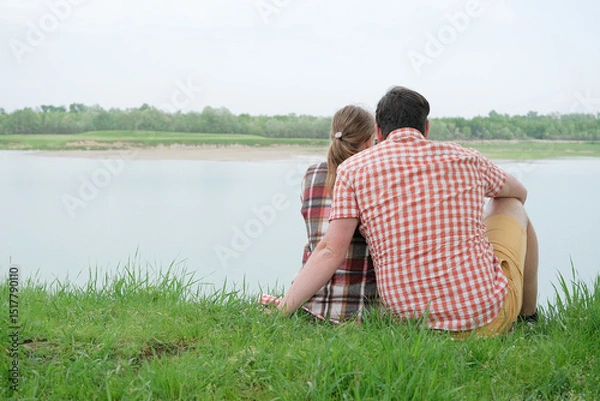 Fototapeta Family on picnic near the lake, looking at view