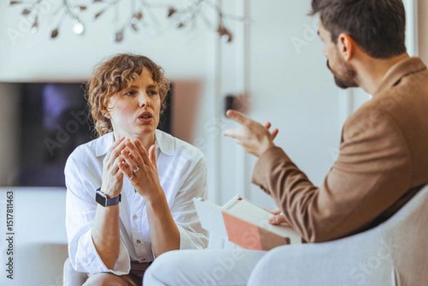 Fototapeta Two Individuals Engaged in a Serious Conversation in a Cozy Setting