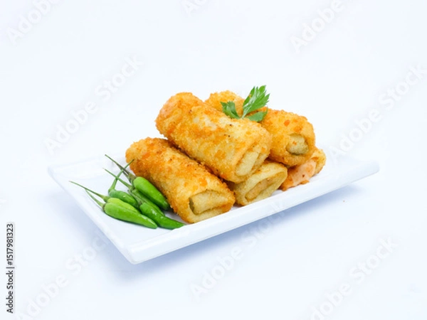 Fototapeta A plate of crispy golden vegetable risol served with green chili peppers and parsley garnish. isolated on white background. risol isolated