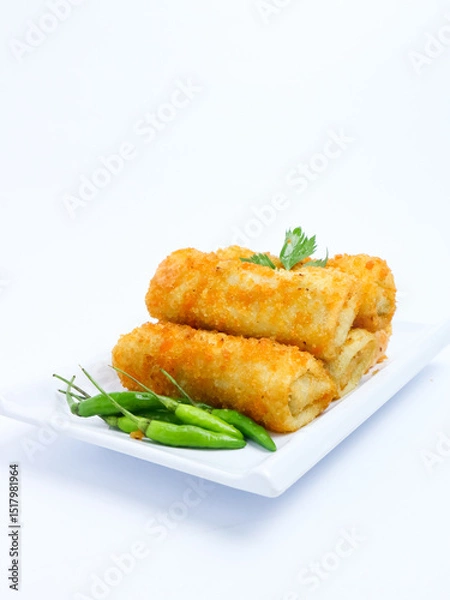 Fototapeta A plate of crispy golden vegetable risol served with green chili peppers and parsley garnish. isolated on white background. risol isolated