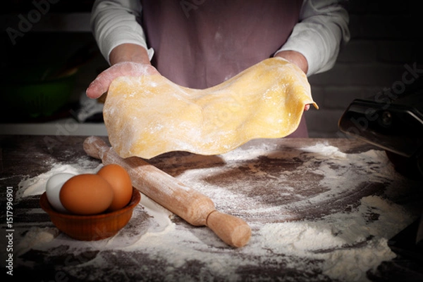 Obraz Baking concept. Caucasian female hands showing the stretched dough sheet.