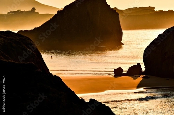 Obraz Spectacular sunset with an orange sky on a beach in Asturias, Cantabrian Sea, Spain