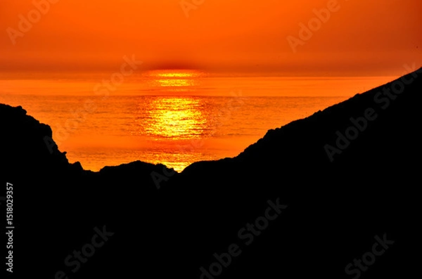 Obraz Spectacular sunset with an orange sky on a beach in Asturias, Cantabrian Sea, Spain