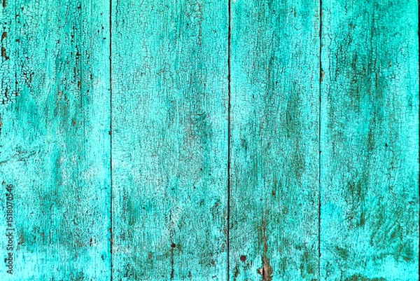 Fototapeta Cracked and weathered turquoise paint on old wooden surface. Perfect rustic background for design projects, websites, posters, and vintage-style artwork.