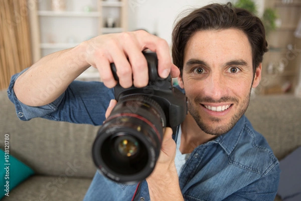 Fototapeta happy photographer working in his studio
