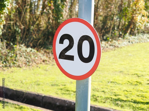 Fototapeta close up of a UK maximum road speed limit sign showing 20 mph as the top speed