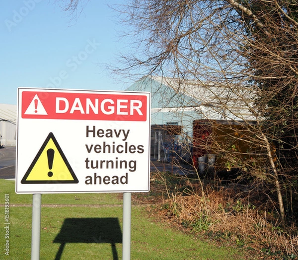 Obraz a warning sign for danger heavy vehicles turning ahead