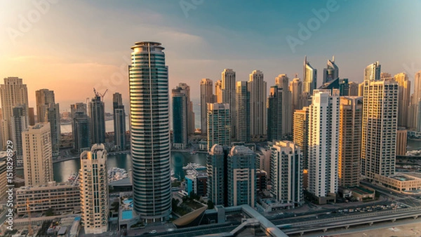 Fototapeta Aerial top view at sunset timelapse of Dubai Marina and JLT in Dubai, UAE